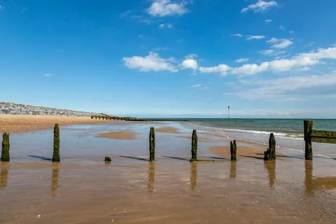 Looking along the beach at low tide, at Camber Sands in Sussex Stock Photos