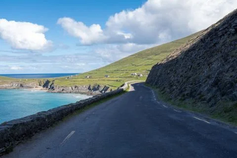 Looking along the empty winding road and rugged cliffs of the Dingle Peninsul Stock Photos