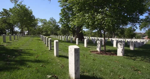 Looking along rows of grave markers in Arlington National Cemetery. Shot in May Stock Footage 59265606
