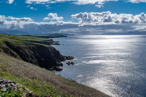 Looking along the rugged cliffs of the Dingle Peninsula, Ireland, bright blue Stock Photos
