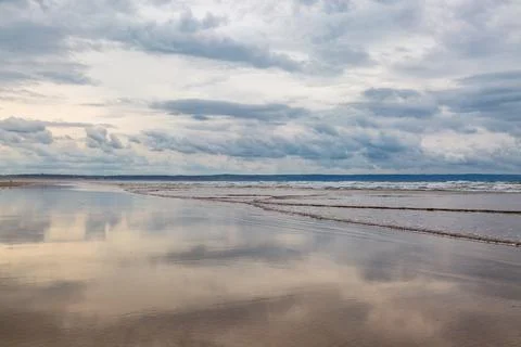 Looking along the sandy beach at low tide, at Saunton Sands in Devon Stock Photos