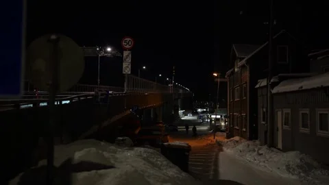 Looking alongside the Tromso bridge at night in snowy winter, Norway Stock Footage 301466449