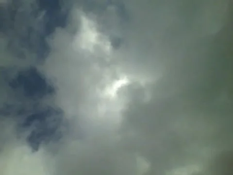 Looking around of the cloudy sky, you can see the sun a little Stock Footage 158963061