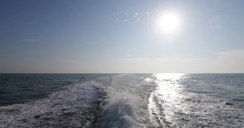 Looking back from old passenger ship, morning sun and wake, slow motion Stock Footage 314773216