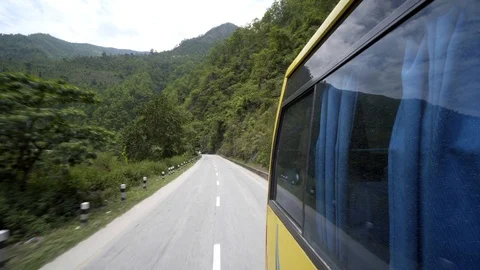 Looking back out of bus window in Nepal with green hills Video stock 91166190