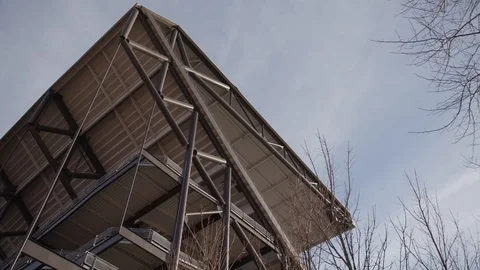 Looking up at the back side rafters of a stadium Stock Footage 102132353