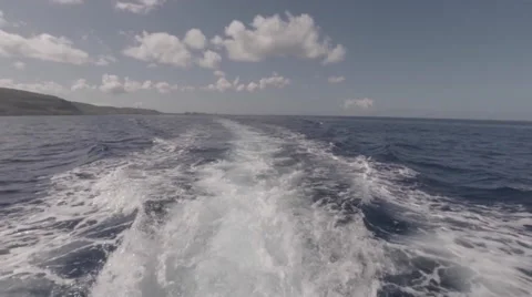 Looking off the back of a swiftly moving boat off the coast of Oahu, Hawaii Stock Footage 49910605