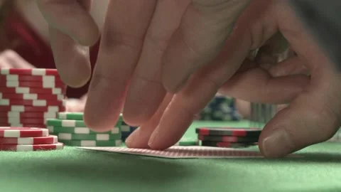 Looking bad poker cards. On the background sexy woman player checking her hand Stock Footage 205717063
