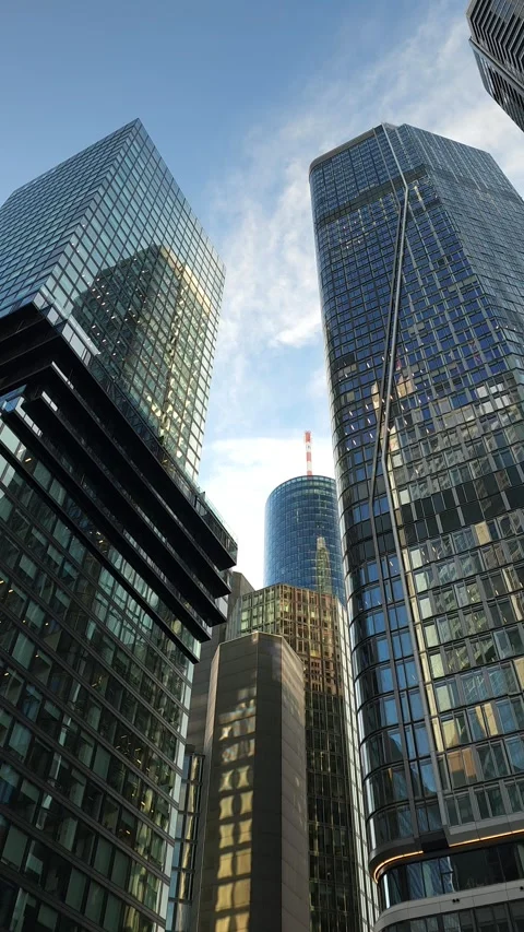 Looking Up Between Modern Skyscrapers Under Blue Sky Stock Footage 344310447