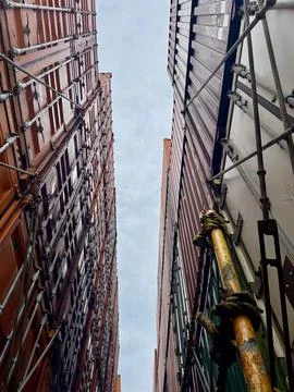 Looking Up Between Stacked Containers From Catwalk On Container Ship Stock Photos