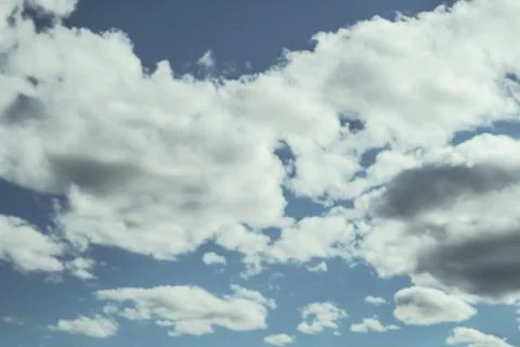 Looking up at a blue overcast summer sky with fluffy, soft white clouds Stock Photos