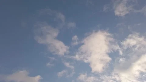 Looking up at blue sky with fast moving clouds in stormy wind in real time Stock Footage 147189837