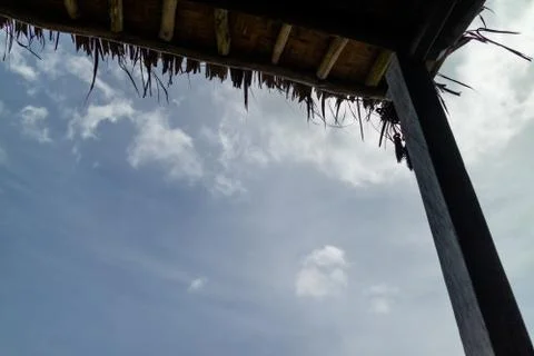 Looking up at the blue sky under a wicker parasol Stock Photos