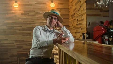 Looking bored and drinking at a counter bar by himself Stock Footage 112191941