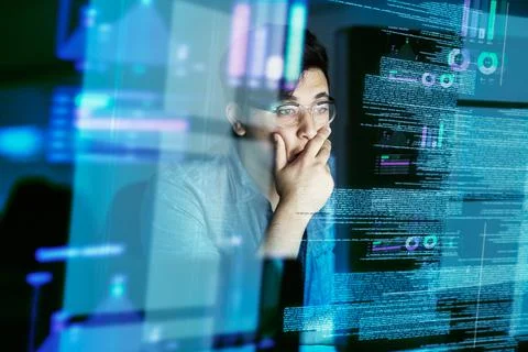 Looking for bugs in the code. Cropped shot of a young computer programmer loo Foto stock