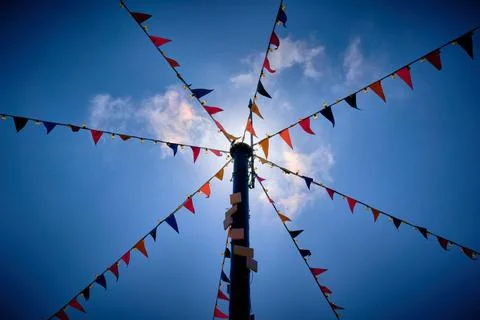 Looking up at bunting flags attached to a pole Stock Photos