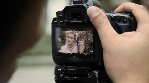 Looking on camcorder display during shooting women Stock Footage 63759746