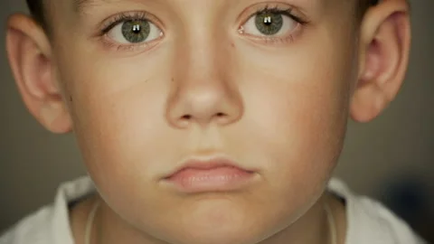 Looking into the camera boy with big eyes Stock Footage 126329513