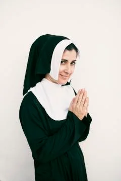Looking at camera praying nun Stock Photos