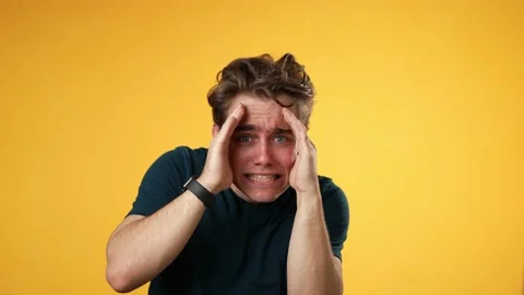 Looking at camera shocked surprised cover face with hands hiding, young guy 20s 스톡 동영상 223262414