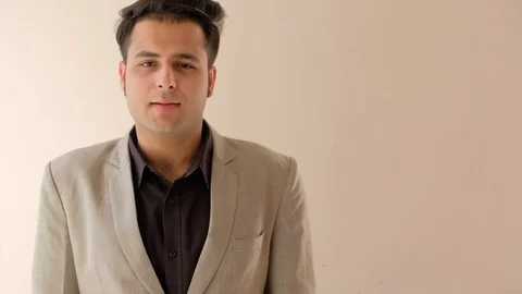 Looking at camera a young man in formals pumps the air at his success and victor Stock Footage 100529745