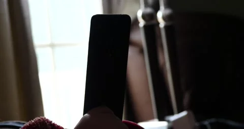 Looking on cell phone back light day close up on smartphone Stock Footage 205489106