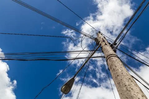 Looking up at a chaotic telegraph pole Stock Photos