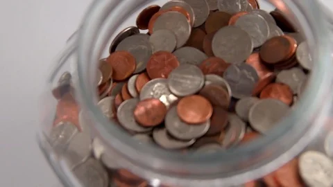Looking into Clear Jar with Coins Stock Footage 74959176