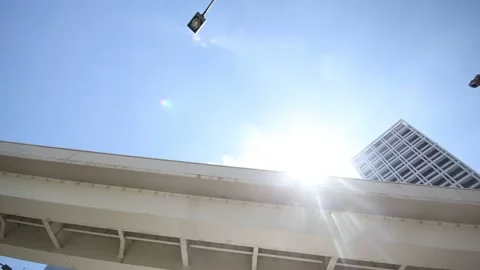 Looking up the clear sky in Tokyo Japan. Highway bridge and a building. Stock Footage 220096757