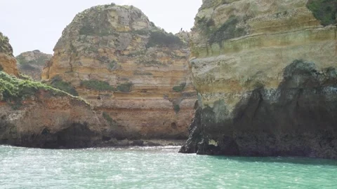 Looking at cliff formation from the ocean on a boat in Algarve Portugal Stock Footage 273674130