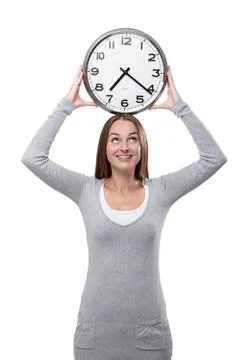 Looking at the clock above her head Stock Photos
