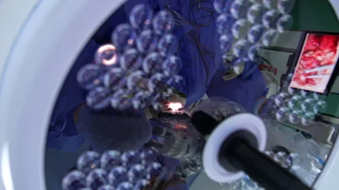 Looking close at the round lamp reflecting a progress of surgery.  Stock Footage 302374820