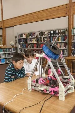 Looking closely at the 3D printer. Stock Photos