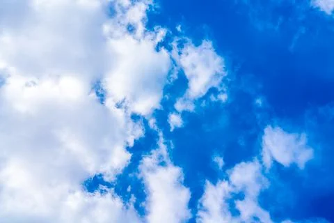 Looking up on a cloudy blue sky on a summers day. Stock Photos