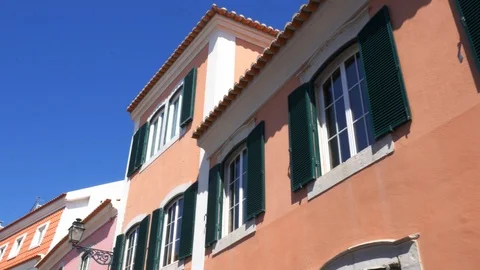 Looking up at colourful and vibrant whitewashed buildings in Cascais, Portugal Stock Footage 114742735