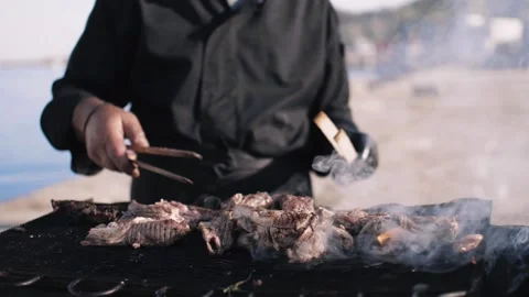 Looking cook hands rolling out a meat on barbecue outdoor. Stock Footage 144815117