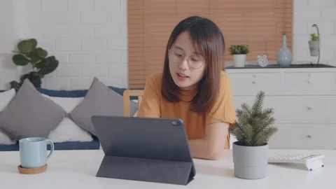 Looking at the device screen makes video learning online or working at home Stock Footage 128188032