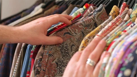 Looking at Different Clothes on a Pole Vídeos de archivo 113283577