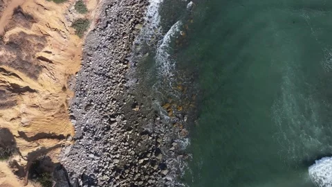 Looking down from an aerial perspective of a clear water beach shoreline Stock Footage 337250558