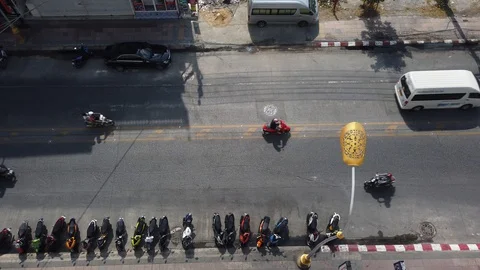 Looking down aerial view of a street in Patong Phuket thailand with cars going b Stock Footage 128228923