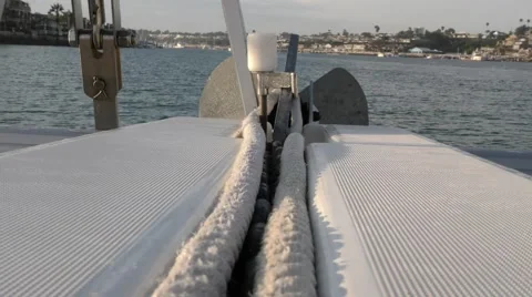 Looking down the anchor chain channel of a catamaran with anchor on end in ha Video stock 67848708