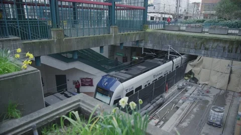 Looking down and panning on subway in outdoor station in Seattle Stock Footage 234034059