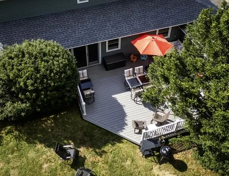 Looking down at a backyard composite deck with furniture set up Stock Photos