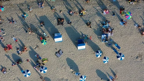 Looking down on a beach full of people and zooming out Stock Footage 103340297