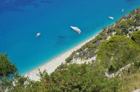Looking down at a beach full of people in the summer in Greece Stock Photos