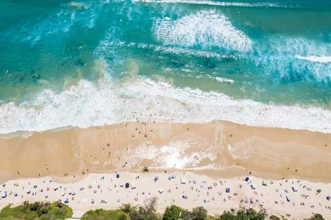 Looking down as beach goers welcome the surf 스톡 사진