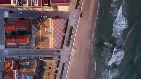 Looking down on the beach next to holiday apartment buildings Stock Footage 258295567