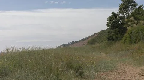 Looking down the beach at sandy cliffs Stock Photos