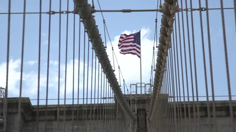 Looking down Brooklyn Bridge towards a flag flying - slow motion Stock Footage 44102710