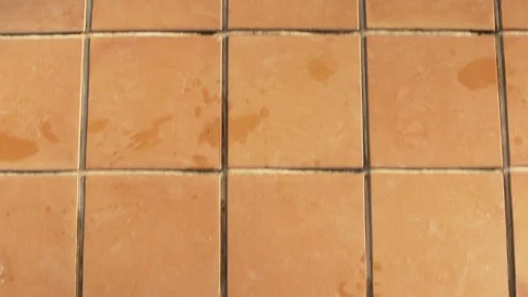Looking down to brown tiled floor, wet at places, walking towards swimming po Stock Footage 252534600
